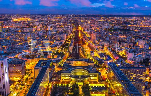 Fototapeta Aerial view of Gare Montparnasse illuminated by blue hour from panoramic Tour Montparnasse. Paris urban cityscape. Parisian style architecture of France in Europe. Night scene.