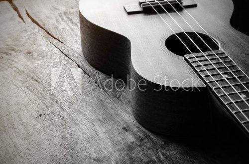 Fototapeta Close up of ukulele on old wood background with soft light