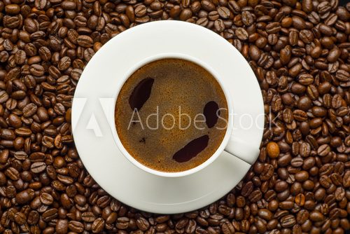 Fototapeta Coffee cup and coffee beans on table
