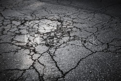 Fototapeta Dark asphalt road with cracks. Background texture