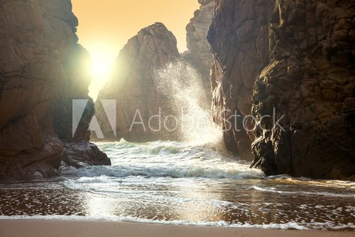 Fototapeta Fantastic big rocks and ocean waves at sundown time