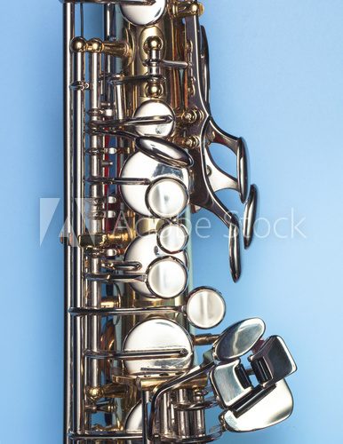 Fototapeta A saxophone on a clean blue background