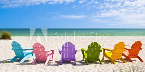 Fototapeta Adirondack Beach Chairs on a Sun Beach in front of a Holiday Vac
