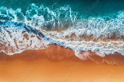 Fototapeta Aerial view of sea waves and sandy beach