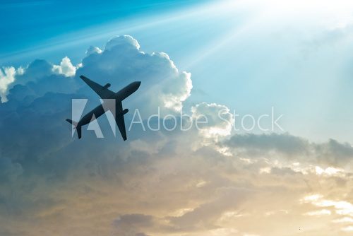 Fototapeta Airplane in the sky and cloud at sunrise