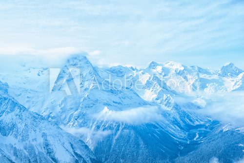 Fototapeta amazing view of winter day landscape Dombaj mountains with blue