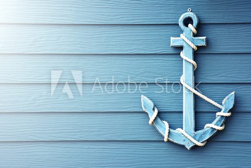 Fototapeta Anchor on blue wooden background.