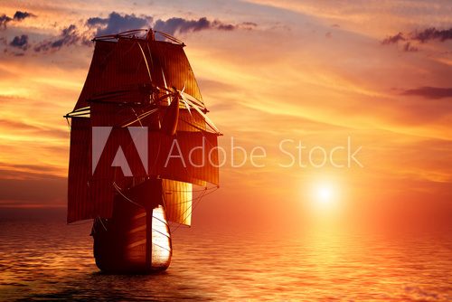 Fototapeta Ancient pirate ship sailing on the ocean at sunset