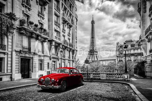 Fototapeta Artistic Paris, France. Eiffel Tower seen from the street with red retro limousine car.