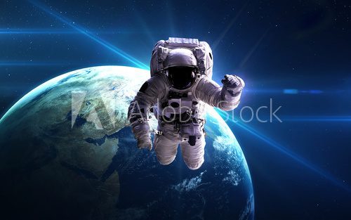 Fototapeta Astronaut in outer space against the backdrop of the planet. Elements of this image furnished by NASA.