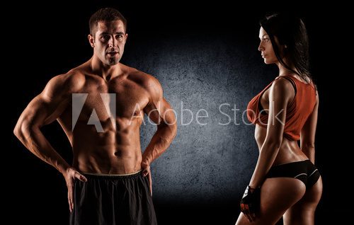 Fototapeta athletic couple poses for the camera