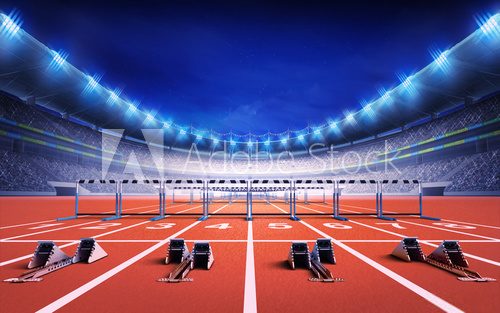 Fototapeta athletics stadium with race track with starting blocks and hurdles