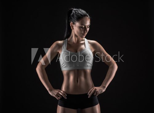 Fototapeta attractive fitness woman, trained female body, lifestyle portrai
