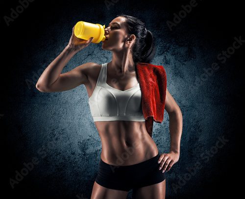 Fototapeta attractive fitness woman, trained female body, lifestyle portrai