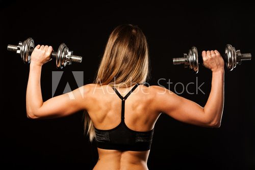 Fototapeta attractive young woman working out with dumbbells - bikini fitne