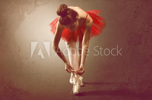 Fototapeta Ballet Dancer ties Shoe
