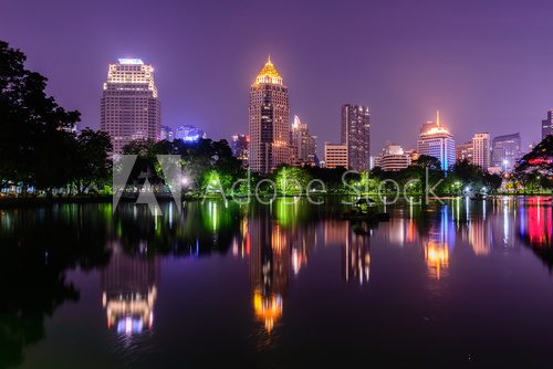 Fototapeta Bangkok skyline and water reflection with urban lake in summer.