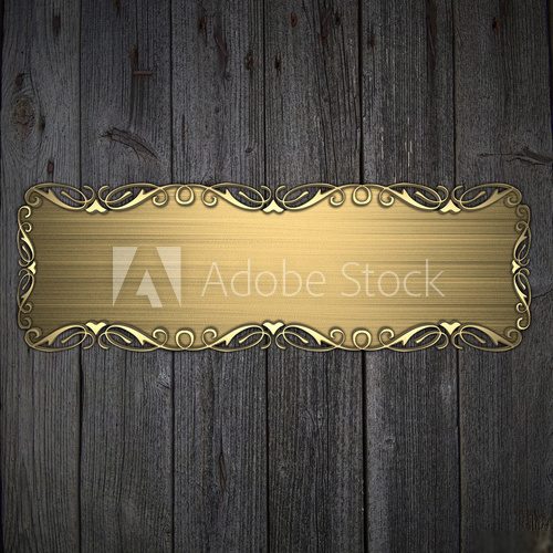 Fototapeta Beautiful pattern on a gold plate on a wood background