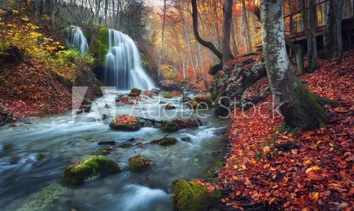 Fototapeta Beautiful waterfall in autumn forest in crimean mountains at sun