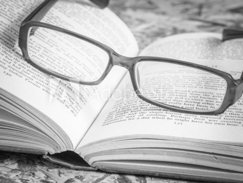 Fototapeta black and white glasses and book