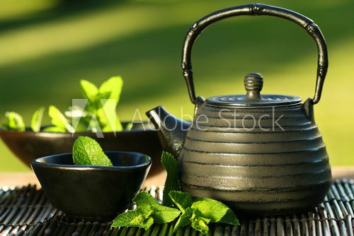 Fototapeta Black iron asian teapot with sprigs of mint for tea