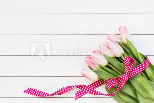 Fototapeta Bouquet of pink tulips on white wooden background. Top view