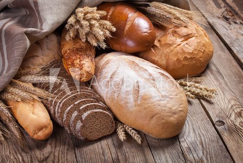 Fototapeta Bread and ears on an old table