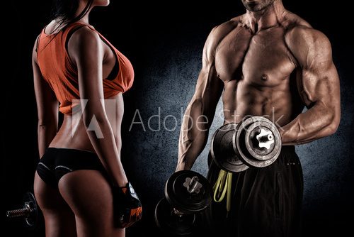 Fototapeta Closeup of a muscular young man lifting weights
