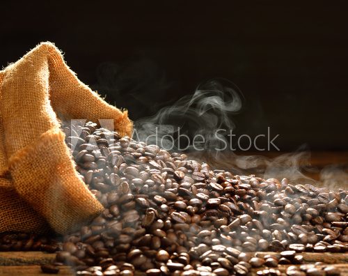 Fototapeta Coffee beans with smoke in burlap sack