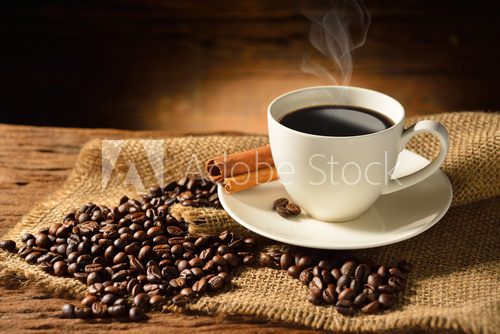 Fototapeta Coffee cup and coffee beans on old wooden background
