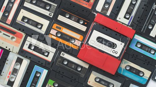 Fototapeta Colored background of old vintage cassettes of the 60-80s