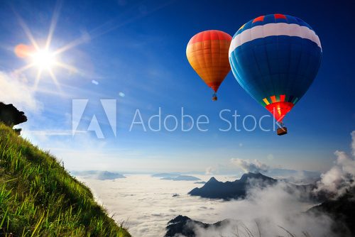 Fototapeta Colorful hot-air balloons flying over the mountain