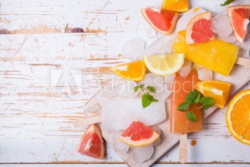 Fototapeta Colorful popsicles on rustic wood background