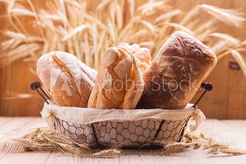 Fototapeta Composition of fresh bread, cereals and grains.