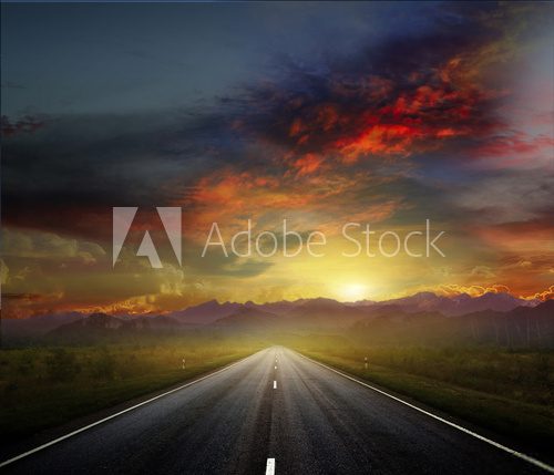 Fototapeta Country road with a dark sky
