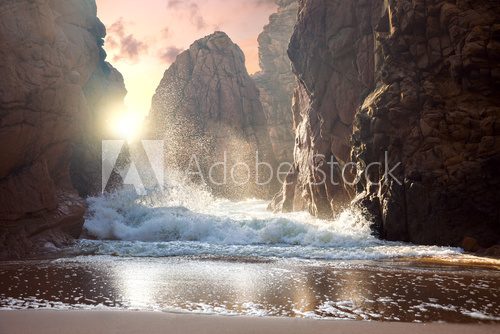 Fototapeta Fantastic big rocks and ocean waves at sundown time. Dramatic