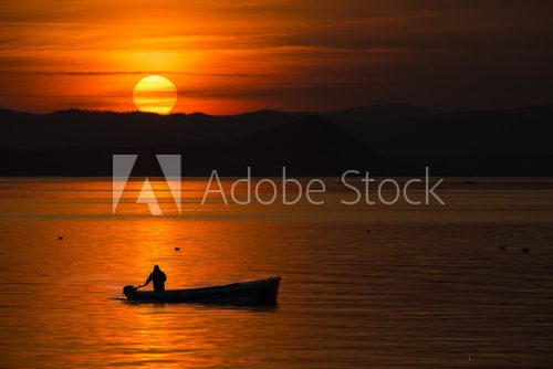Fototapeta fishing boat in the sunset