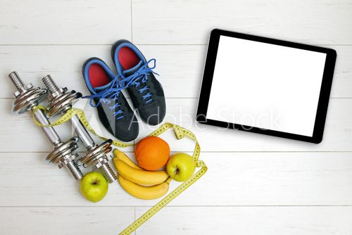 Fototapeta fitness equipment and fruits on white wooden plank floor