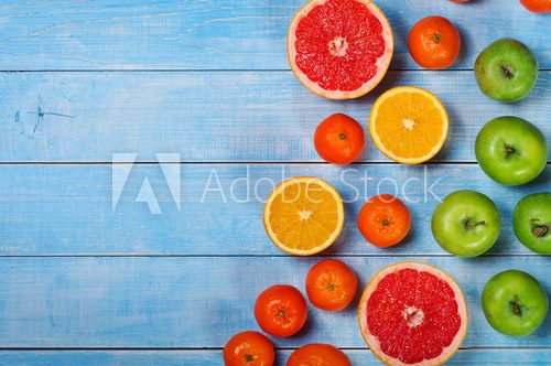 Fototapeta Fruit background - grapefruit, apples, oranges and tangerines