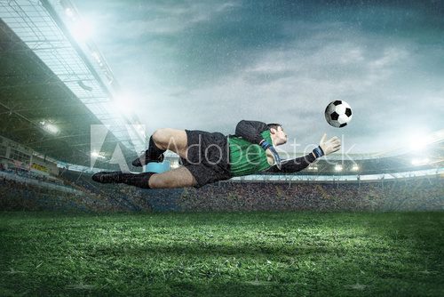 Fototapeta Goalkeeper with ball in action outdoors.