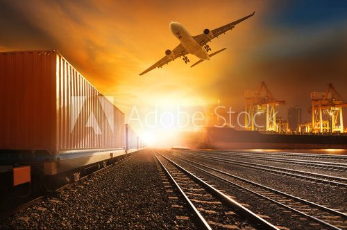 Fototapeta industry container trainst running on railways track and commerc