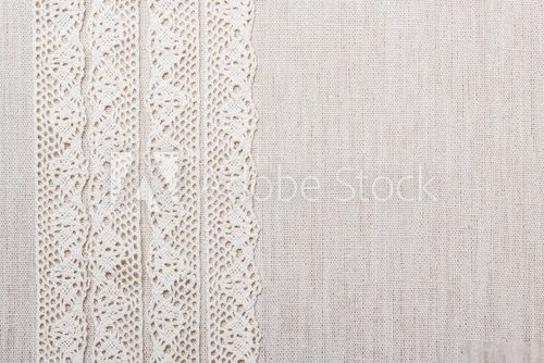 Fototapeta Lace ribbon on linen cloth background