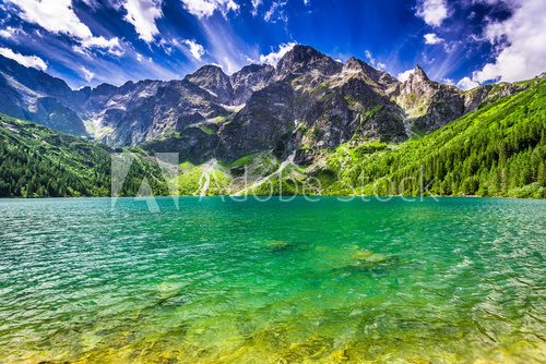 Fototapeta Lake in the middle of the mountains at dawn