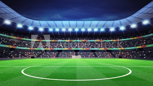 Fototapeta lighted football stadium with fans in the stands