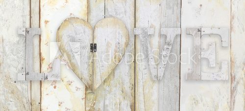 Fototapeta love text with heart shape on wood planks grunge texture backgro