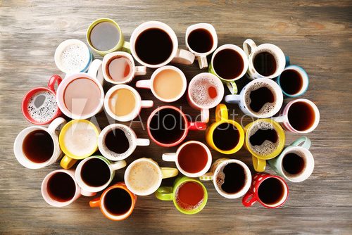 Fototapeta Many cups of coffee on wooden table, top view