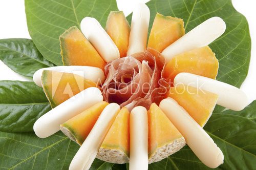 Fototapeta melon with prosciutto and breadsticks