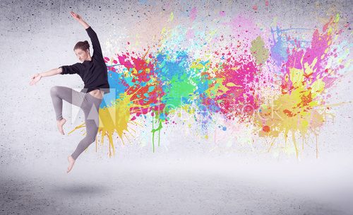 Fototapeta Modern street dancer jumping with colorful paint splashes