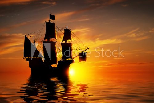 Fototapeta Old ancient pirate ship on peaceful ocean at sunset.