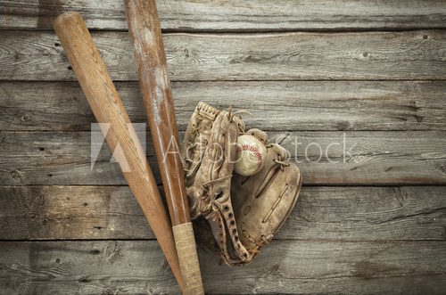 Fototapeta Old baseball with mitt and bats on rough wood